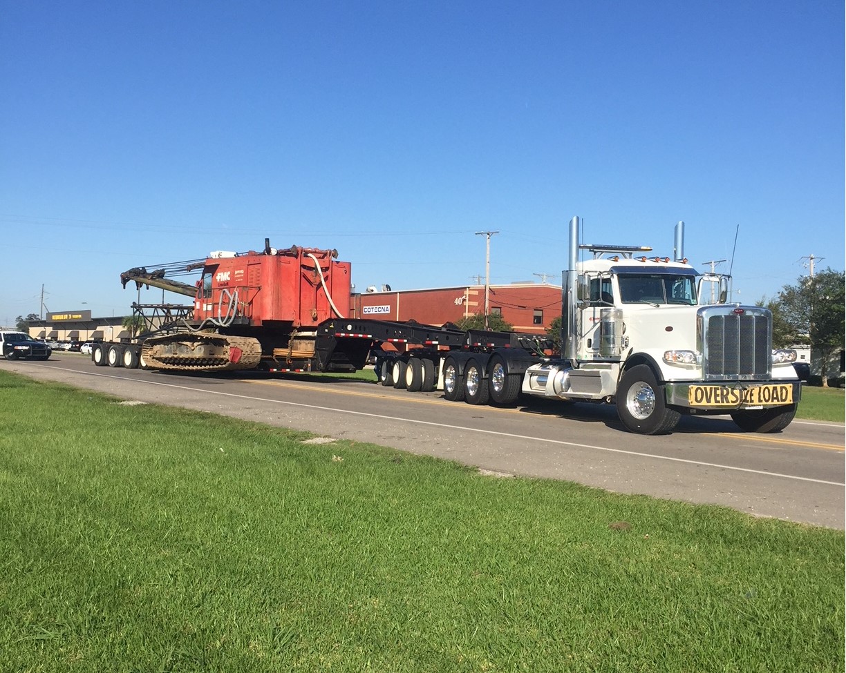 Truck moving heavy equipment